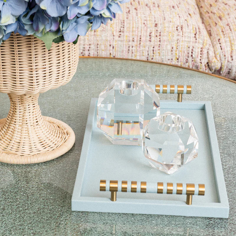 Decorative tray with crystal heart and diamond-shaped objects on a textured surface.