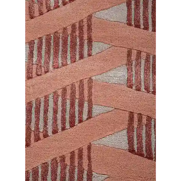 A close-up of a textured area rug featuring a geometric pattern of dusty pink diagonal bands and vertical dark red stripes over a light gray background.
